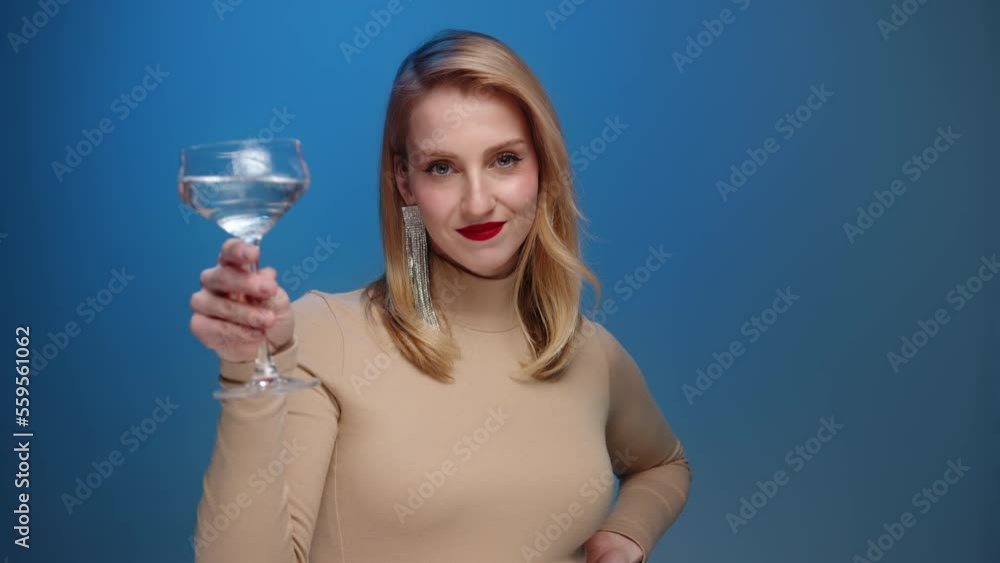 Portrait of a glamorous model with red lipstick enjoying a party. Close-up view of attractive woman enjoying festive champagne. High quality 4k footage Portrait of a glamorous model with red lipstick enjoying a party. Close-up view of attractive woman enjoying festive champagne. High quality 4k footage