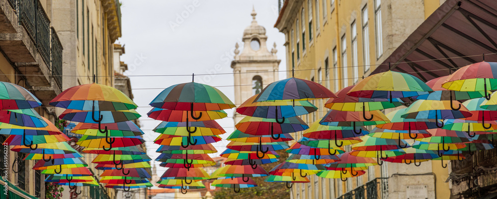 Panoramic photo of the umbrellas in Pink street in Lisbon, Portugal