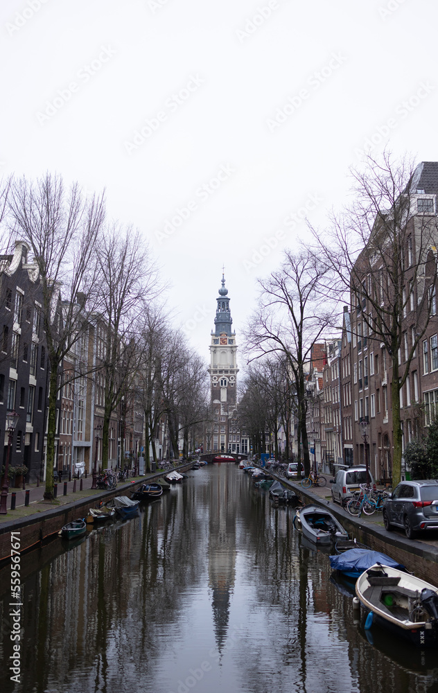 Groenburgwal Canal in Amsterdam. There is beautiful Zuiderkerk tower in the background.