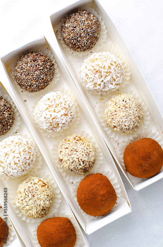 Assorted vegan sweets, Delicious Candy Balls with seeds, dried fruit and cocoa powder, Healthy Candies Assorted vegan sweets, Delicious Candy Balls with seeds, dried fruit and cocoa powder, Healthy Candies