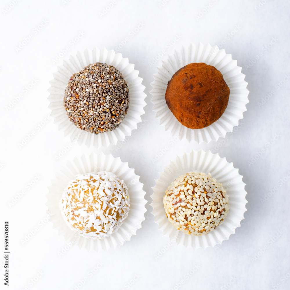 Assorted vegan sweets, Delicious Candy Balls with seeds, dried fruit and cocoa powder, Healthy Candies Assorted vegan sweets, Delicious Candy Balls with seeds, dried fruit and cocoa powder, Healthy Candies