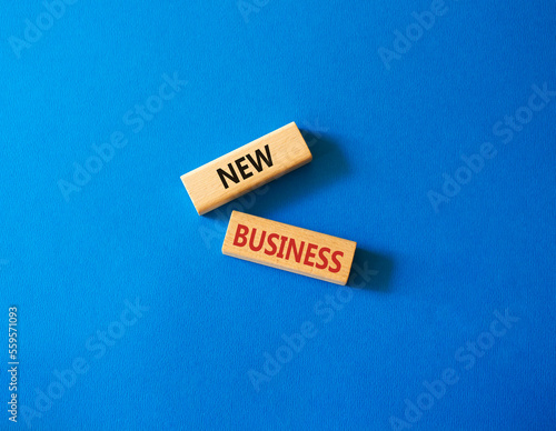 New business symbol. Concept words New business on wooden blocks. Beautiful blue background. Business and New business concept. Copy space.