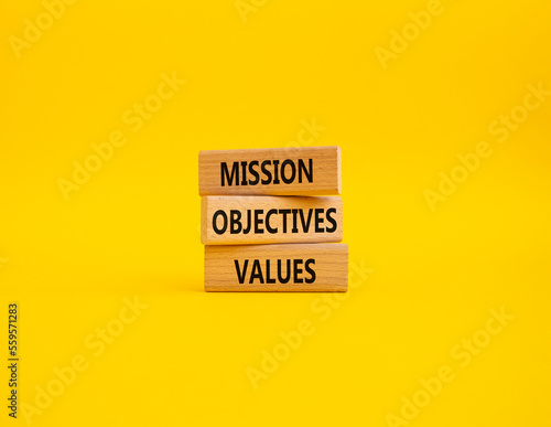 Mission Objectives Values symbol. Concept words Mission Objectives Values on wooden blocks. Beautiful yellow background. Business and Mission Objectives Values concept. Copy space