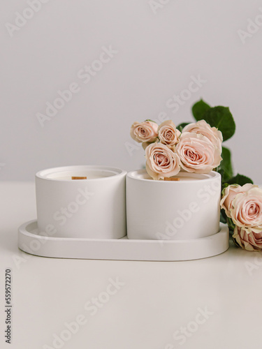 Two coconut wax candles in concrete cups. Scented candles for interior. Candles with the aroma of roses. Space for text