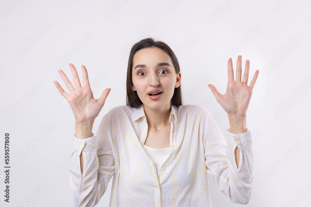 Young beautiful woman with facial expression of surprise standing over white background. Young beautiful woman with facial expression of surprise standing over white background.