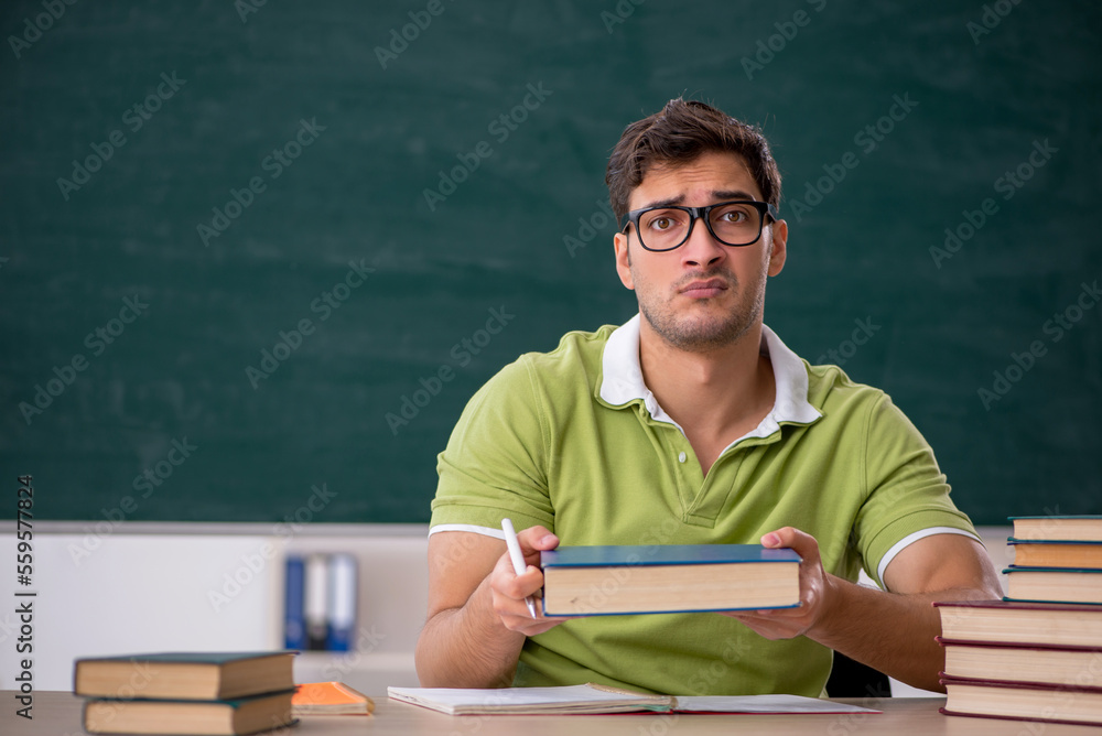 Young male student sitting in the classroom Young male student sitting in the classroom