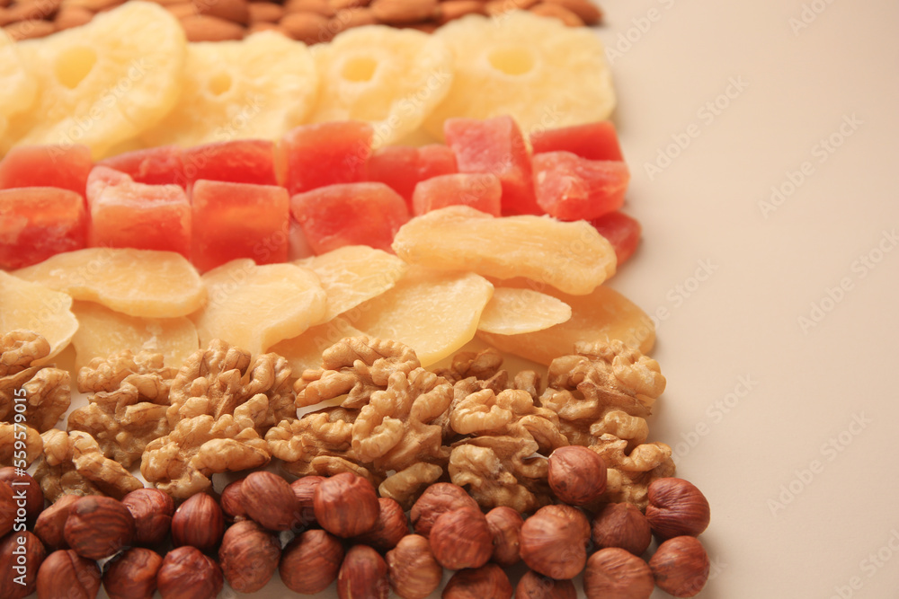 Different tasty nuts and dried fruits on beige background Different tasty nuts and dried fruits on beige background