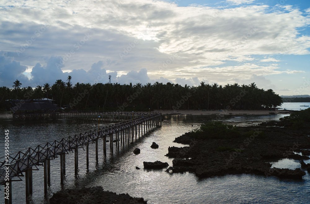 Beautiful landscape. Sunset on the seashore. Wooden bridge on Cloud Nine beach, Siargao Island Philippines. Beautiful landscape. Sunset on the seashore. Wooden bridge on Cloud Nine beach, Siargao Island Philippines.