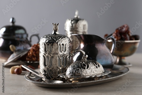 Tea, date fruits and Turkish delight served in vintage tea set on wooden table