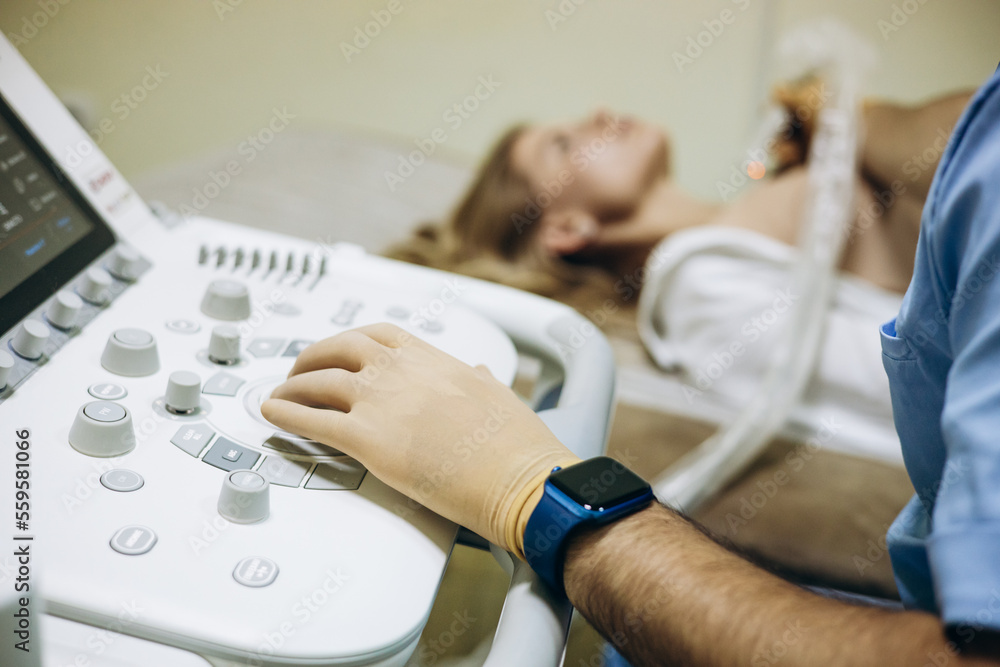 Doctor with patient doing ultrasound check-up Doctor with patient doing ultrasound check-up