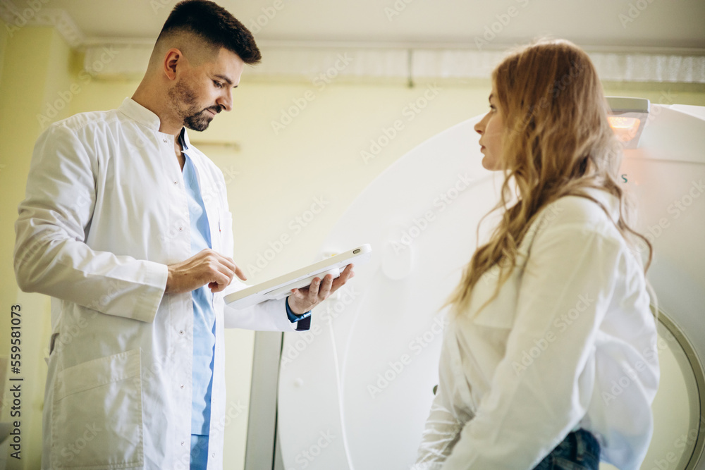 Fototapeta premium Man doctor with patient preparing before MRI scan