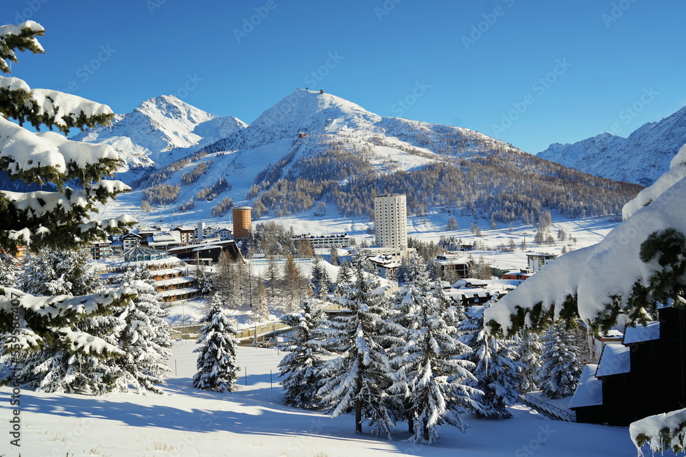 Overview of the snow-covered alpine village of Sestriere, which was the site of the Winter Olympics in 2006. Sestriere, Piedmont, Italy - obrazy, fototapety, plakaty 