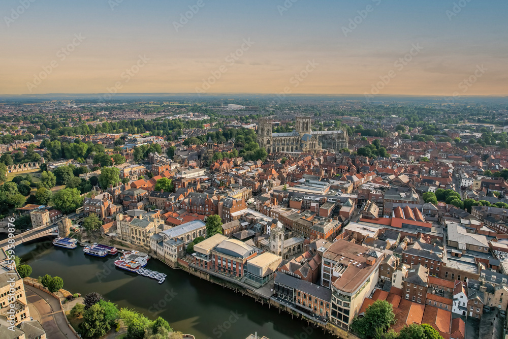 The drone aerial view of York at sunrise, England.  York is a cathedral city with Roman origins, sited at the confluence of the rivers Ouse and Foss in North Yorkshire, England.