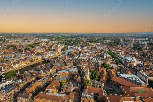The drone aerial view of York at sunrise, England. York is a cathedral city with Roman origins, sited at the confluence of the rivers Ouse and Foss in North Yorkshire, England.