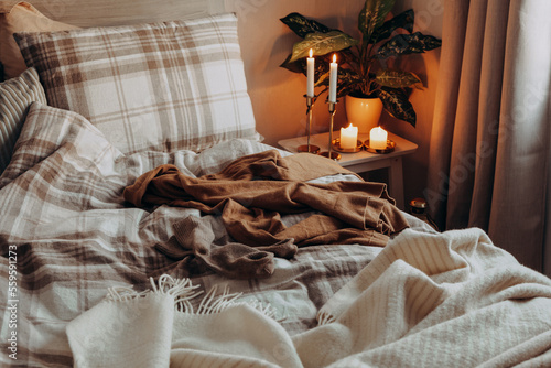 cozy scandinavian bedroom interior in natural tones, real life mess disorder