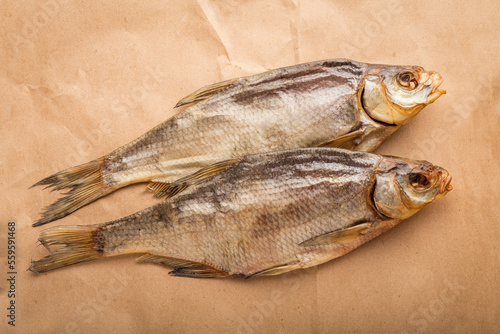 Two dried fish bream on a Kraft paper background. The concept of an appetizer for beer. top view photo