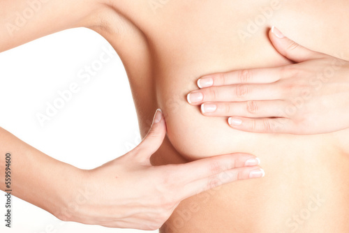 Young topless woman doing breast self-exam. Breast cancer awareness.