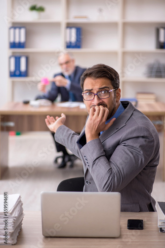 Two male colleagues working in the office