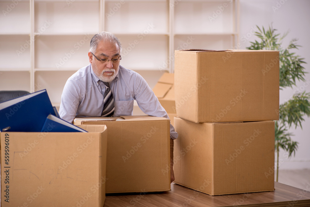 Old male employee in office relocation concept Old male employee in office relocation concept