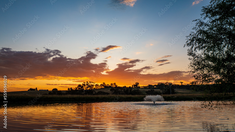 Sunset over dam with fountain