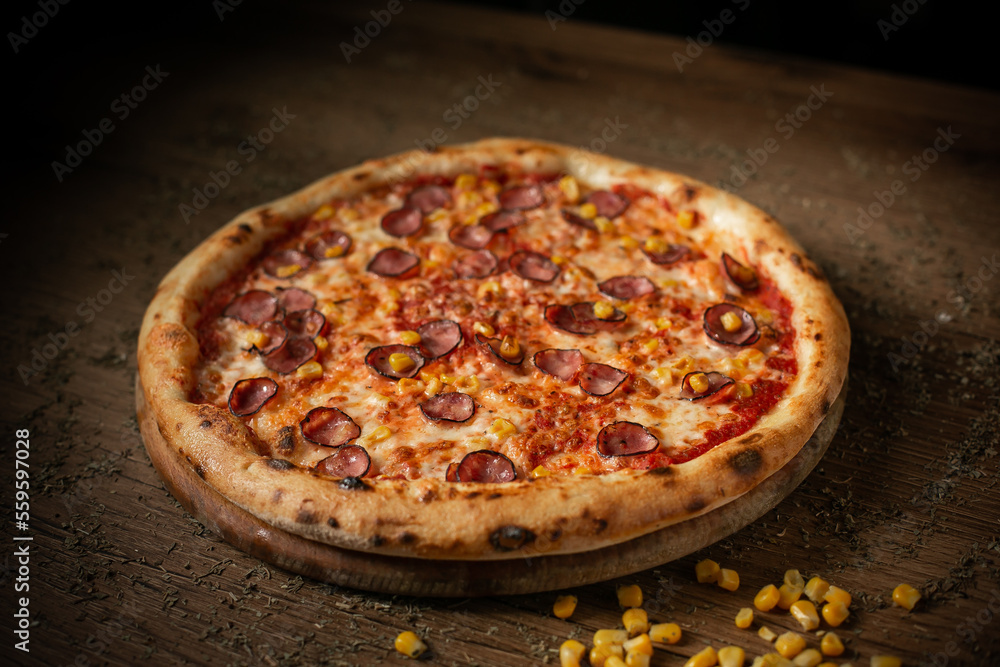 delicious tomato pizza with sausages and corn
