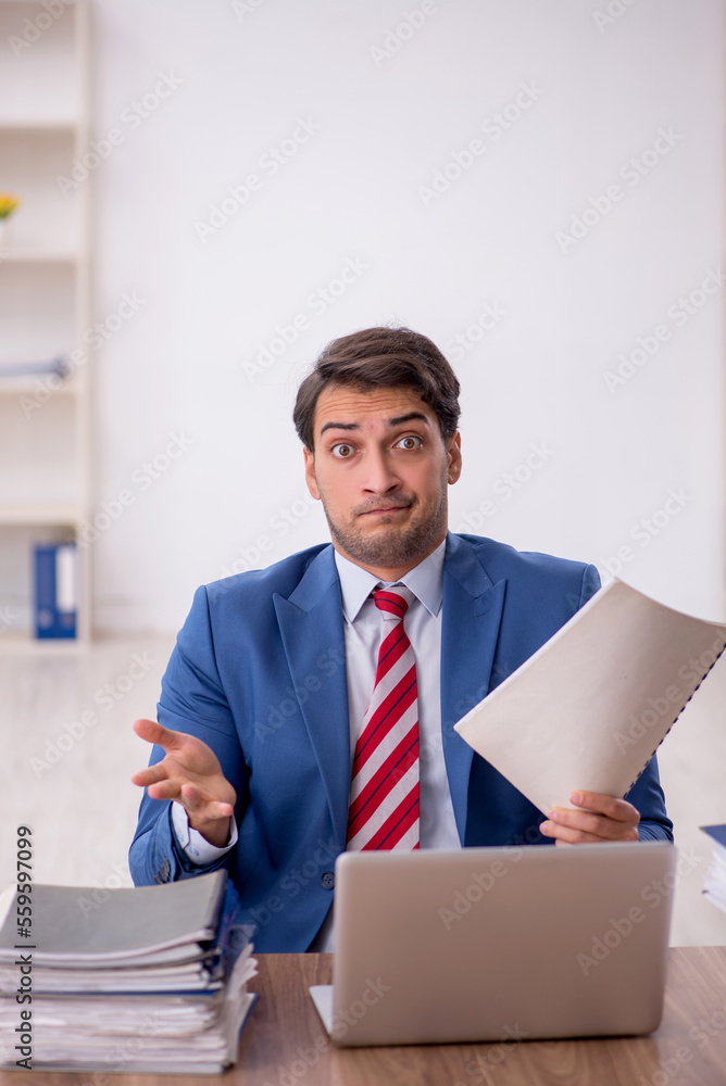 Young male employee working in the office Young male employee working in the office