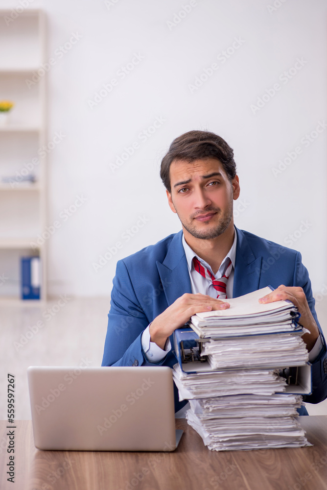 Young male employee working in the office