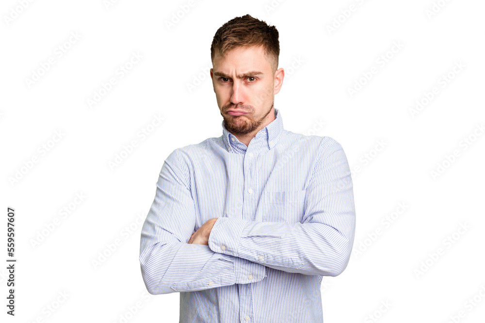 Young caucasian man cut out isolated frowning face in displeasure, keeps arms folded. Young caucasian man cut out isolated frowning face in displeasure, keeps arms folded.