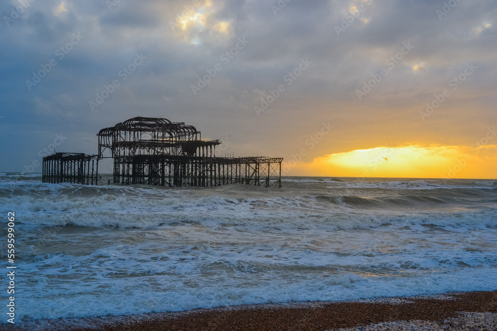 Burnt out Brighton Pier during a storm and sunset Burnt out Brighton Pier during a storm and sunset