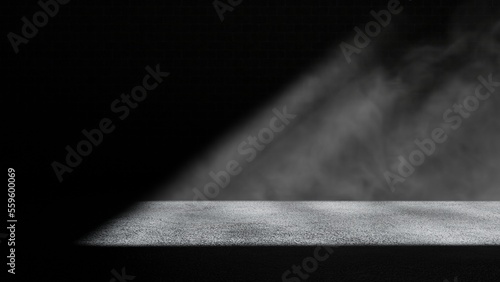 Light falling on concrete floor in a dark dusty room