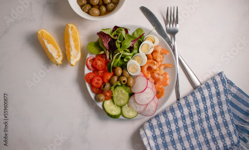 Salad with shrimps, tomatoes in a plate