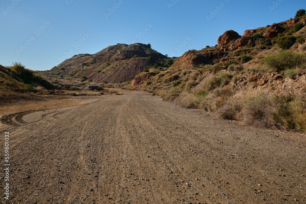 Gravel road in mountains.
Gravel road in a quarry with iron ore.