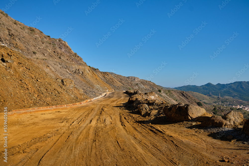 Gravel road in mountains.
Gravel road in a quarry with iron ore.