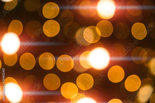 Abstract bokeh background burning light bulbs evening city and garlands. © freeman83