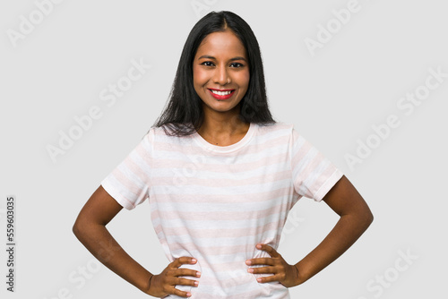Fotografia Young Indian woman cut out isolated on white background confident keeping hands on hips