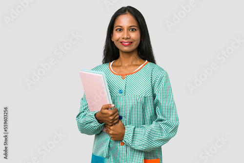 Primary school indian teacher holding books isolated on grey background photo