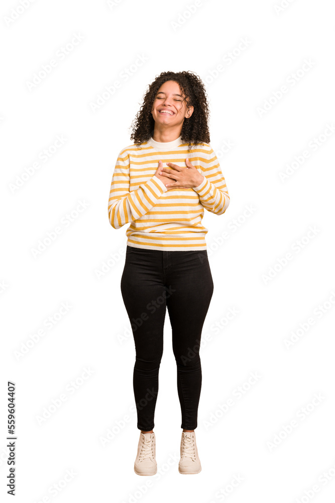 Young african american woman with curly hair cut out isolated laughing keeping hands on heart, concept of happiness. Young african american woman with curly hair cut out isolated laughing keeping hands on heart, concept of happiness.