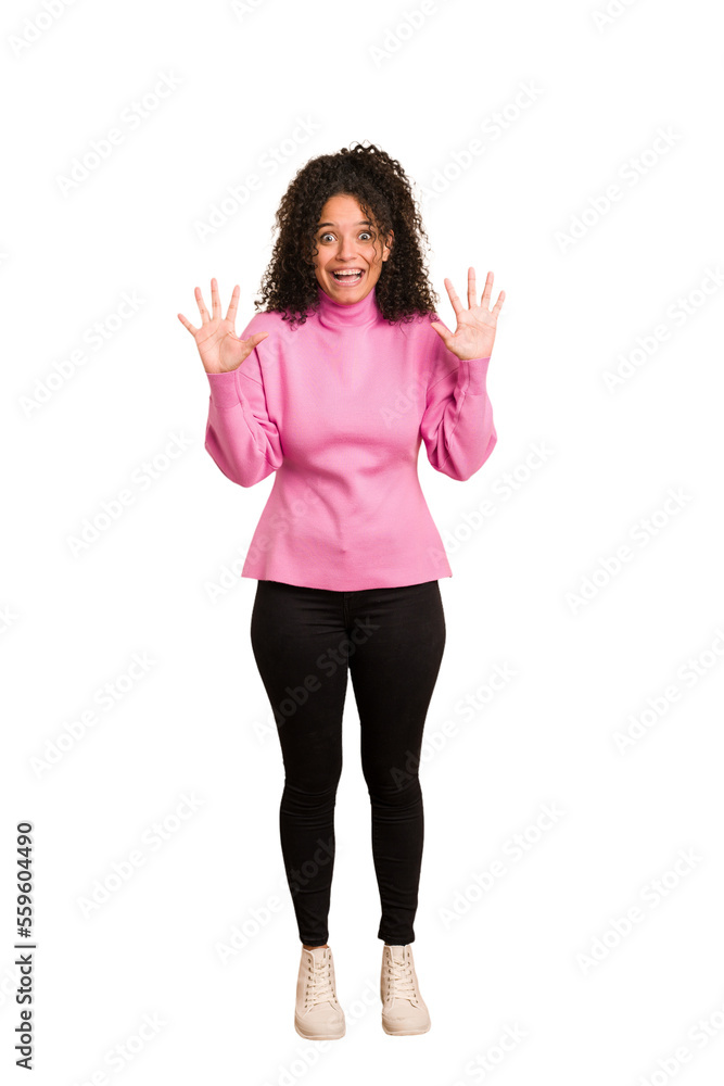Young african american woman with curly hair cut out isolated receiving a pleasant surprise, excited and raising hands. Young african american woman with curly hair cut out isolated receiving a pleasant surprise, excited and raising hands.