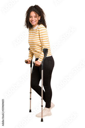 Vászonkép Full body young african american woman with crutches isolated