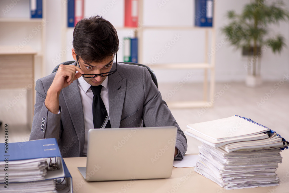 Young male employee working in the office Young male employee working in the office