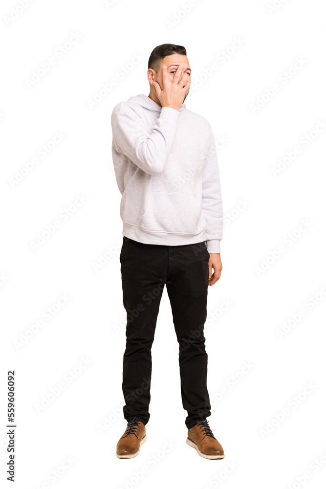 Full body adult latin man cut out isolated blink through fingers frightened and nervous. Full body adult latin man cut out isolated blink through fingers frightened and nervous.