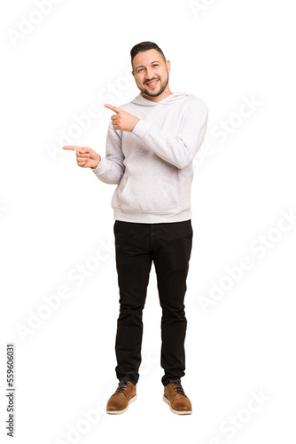 Full body adult latin man cut out isolated looking far away keeping hand on forehead.