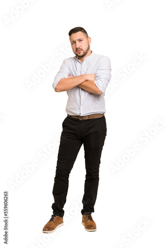Full body adult latin man cut out isolated suspicious, uncertain, examining you.