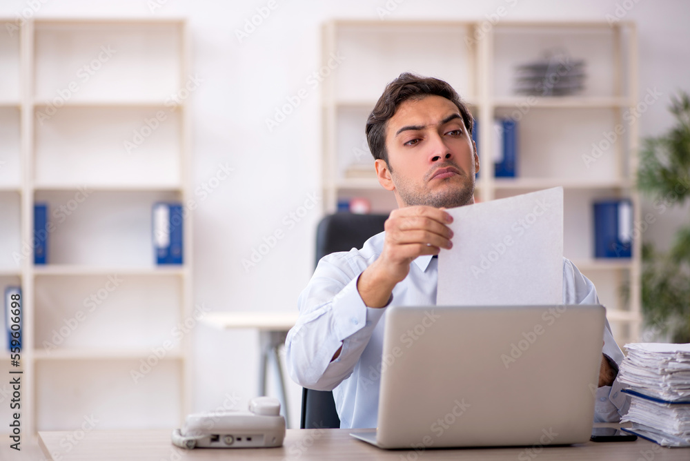 Young male employee working in the office Young male employee working in the office