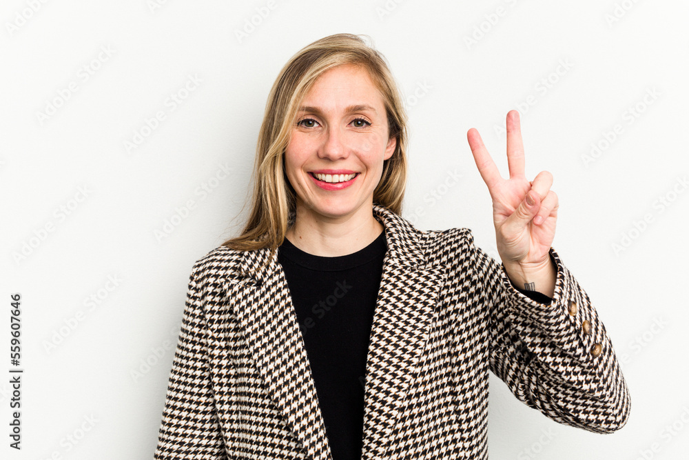 Young caucasian woman isolated on white background joyful and carefree showing a peace symbol with fingers. Young caucasian woman isolated on white background joyful and carefree showing a peace symbol with fingers.