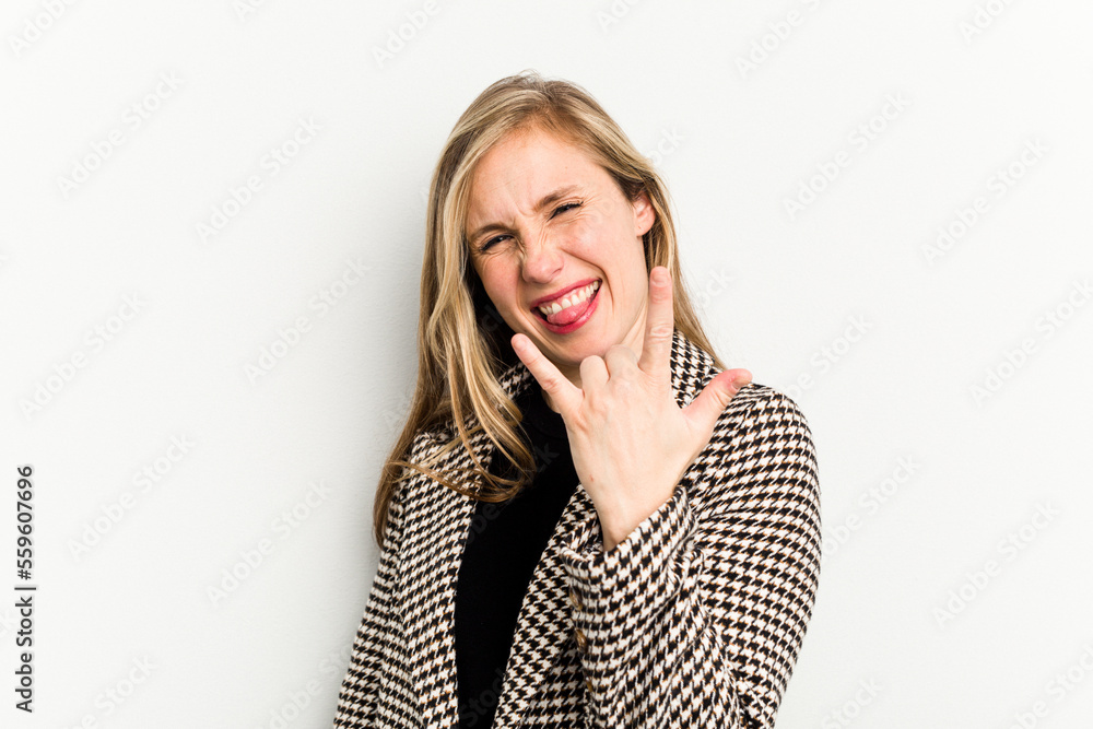 Young caucasian woman isolated on white background showing rock gesture with fingers Young caucasian woman isolated on white background showing rock gesture with fingers
