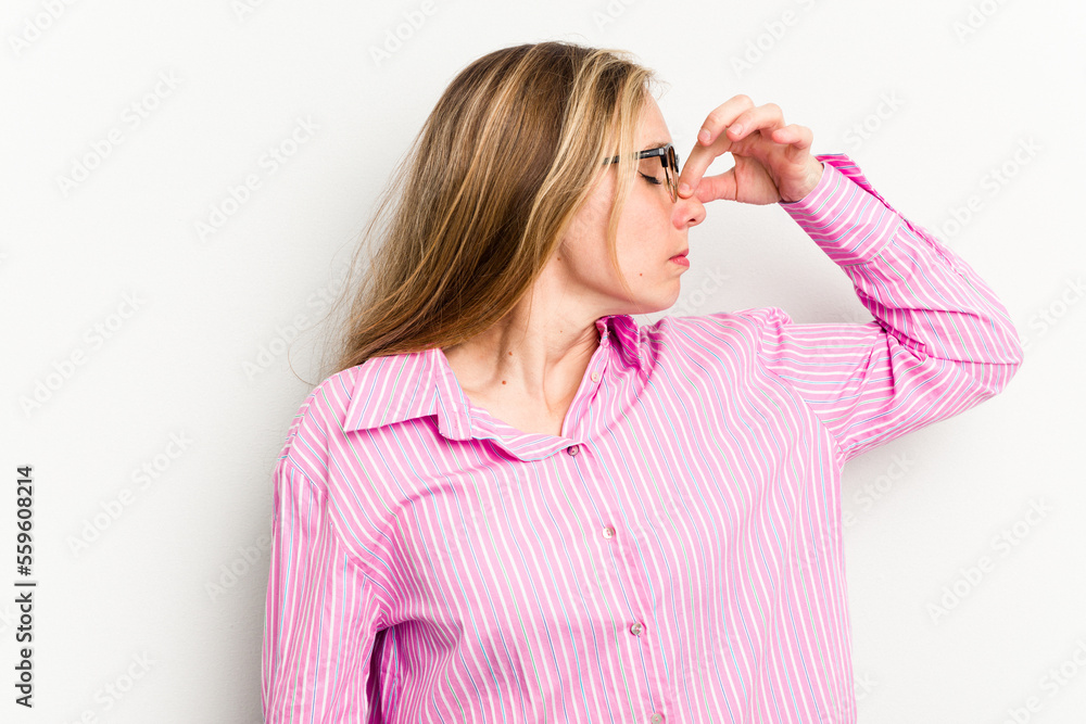 Young caucasian woman isolated on white background having a head ache, touching front of the face. Young caucasian woman isolated on white background having a head ache, touching front of the face.