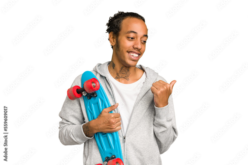 Young skater African American man isolated points with thumb finger away, laughing and carefree.