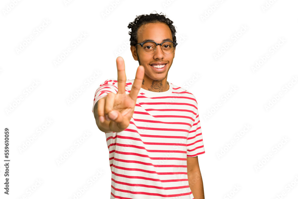 Young African American man isolated joyful and carefree showing a peace symbol with fingers. Young African American man isolated joyful and carefree showing a peace symbol with fingers.