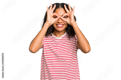 Young african american woman with curly hair cut out isolated showing okay sign over eyes